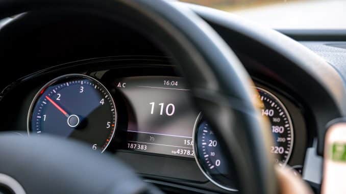 Steering wheel in a car close up, high speed driving on the road.