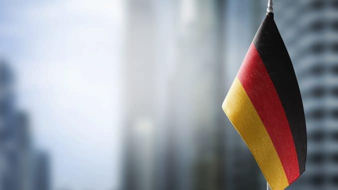 A small flag of Germany on the background of a blurred background